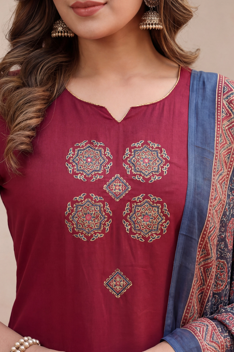 Maroon embroidered top with a blue and patterned saree