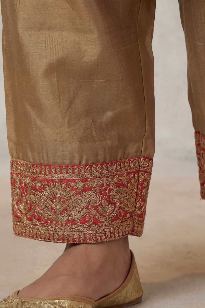 close up of embroidered pants in antique gold kurta pant set with red detailing