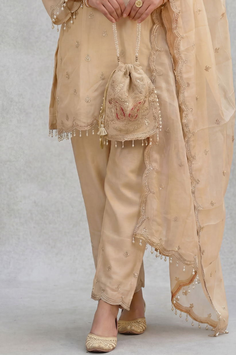 Beige embroidered kurta pant set with matching potli bag for women