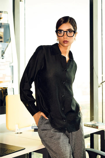Woman wearing a black Chanderi regular fit shirt styled with printed pants for office wear
