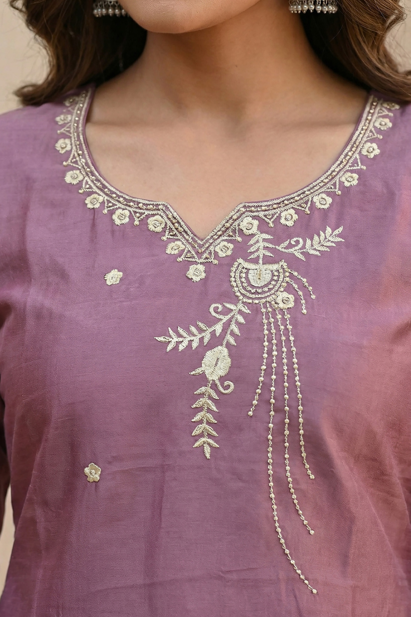 Woman wearing dusty mauve embroidered kurta set with dupatta and straight pants for festive ethnic wear