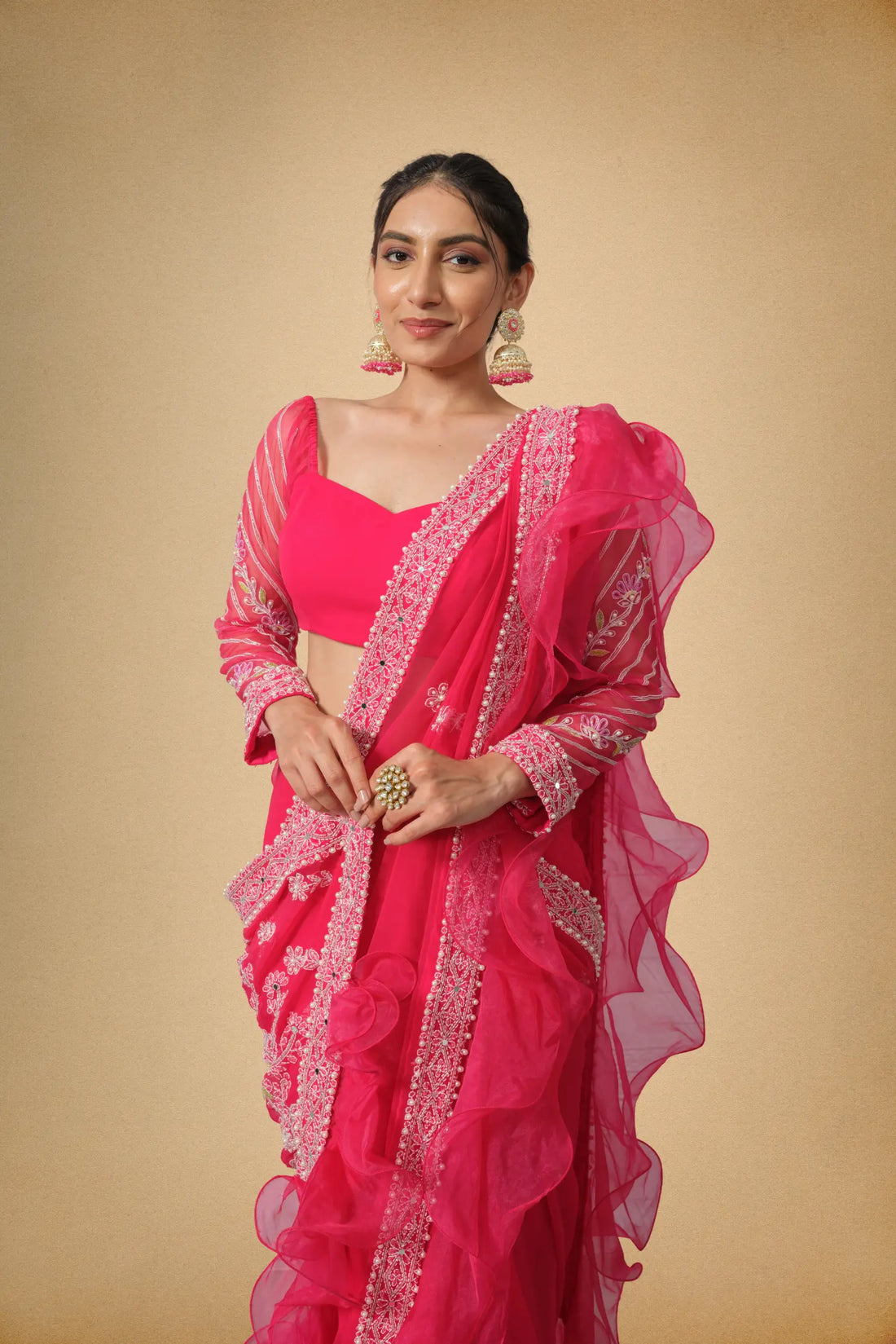Hot pink designer saree with organza ruffle border front view