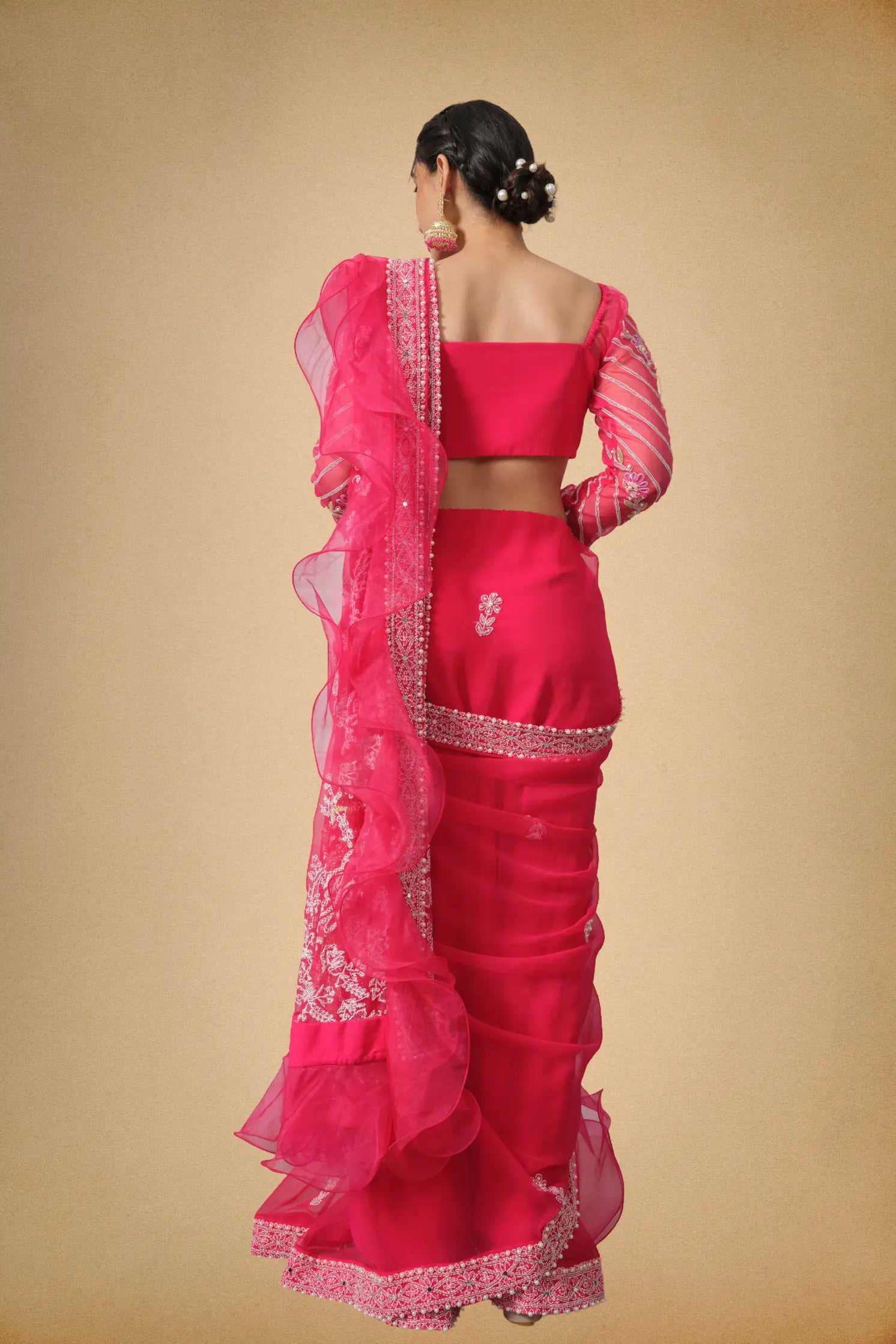 Back side view of hot pink designer saree with ruffle detailing