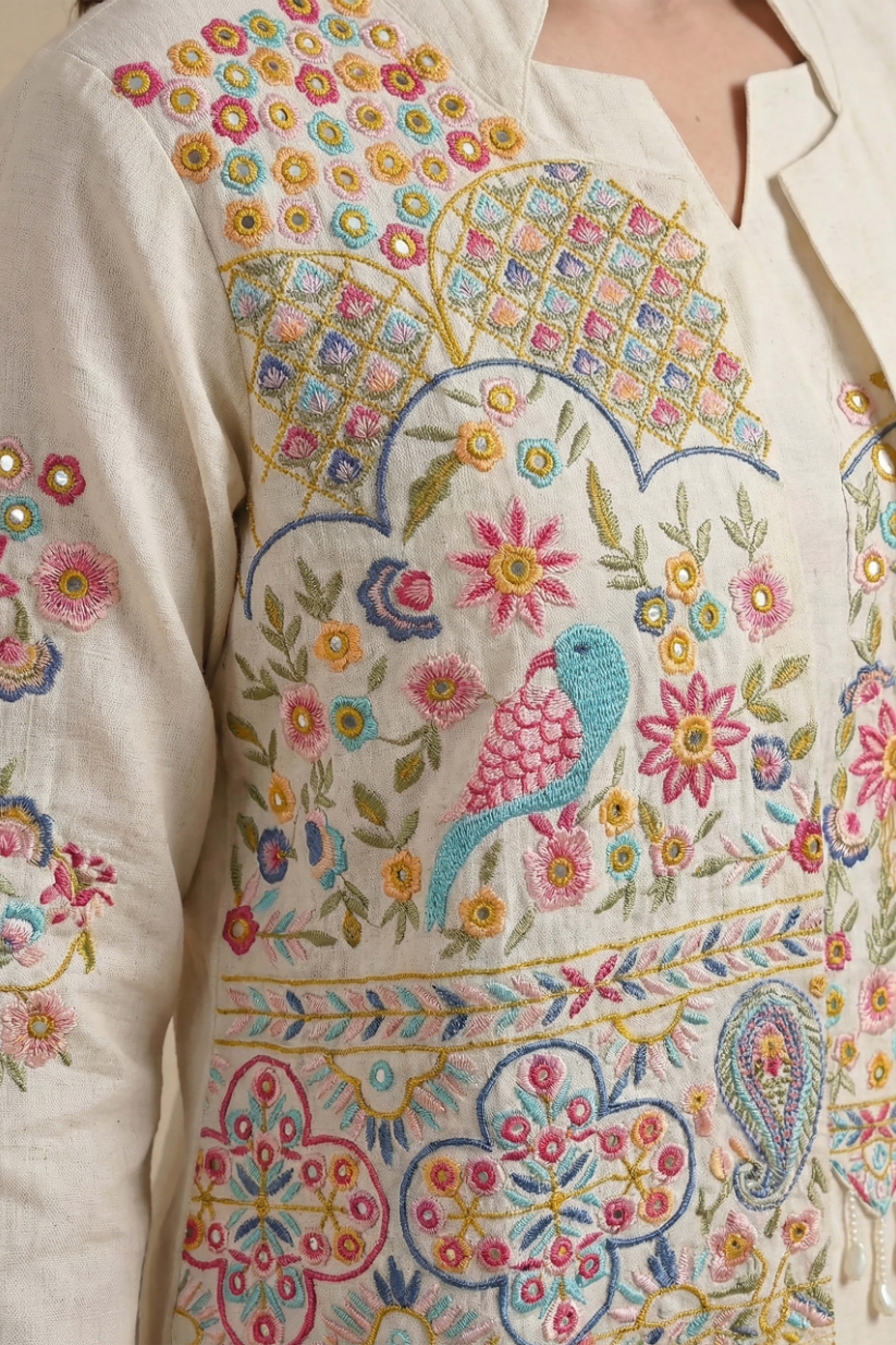 Woman wearing ivory embroidered kurta set with jacket and palazzo pants