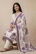 Woman wearing ivory floral printed kurta set with purple dupatta seated pose for women ethnic wear