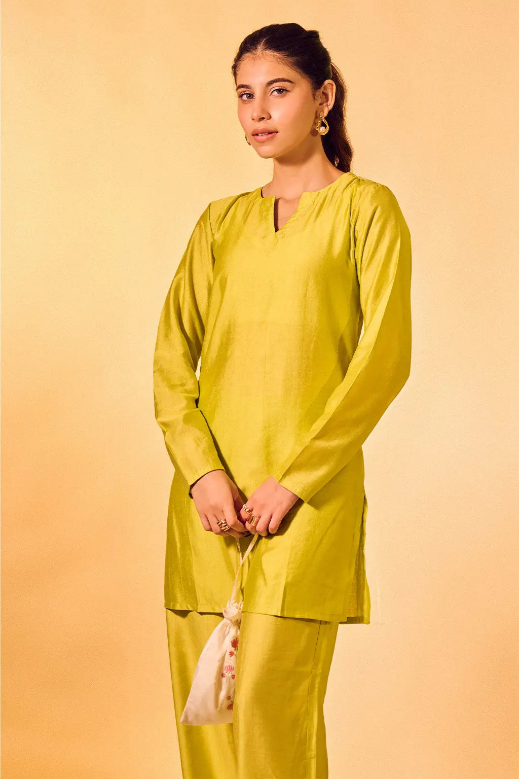 Woman wearing lime green Chanderi kurta set with straight pants and V-neck design