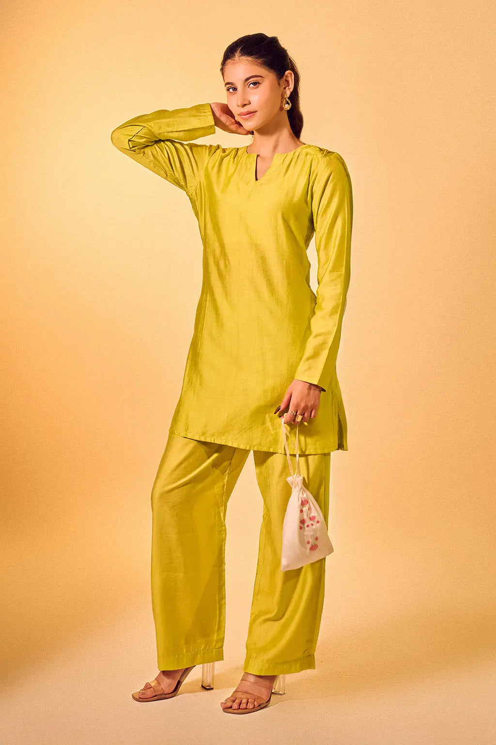 Woman wearing lime green Chanderi kurta set with straight pants and V-neck design