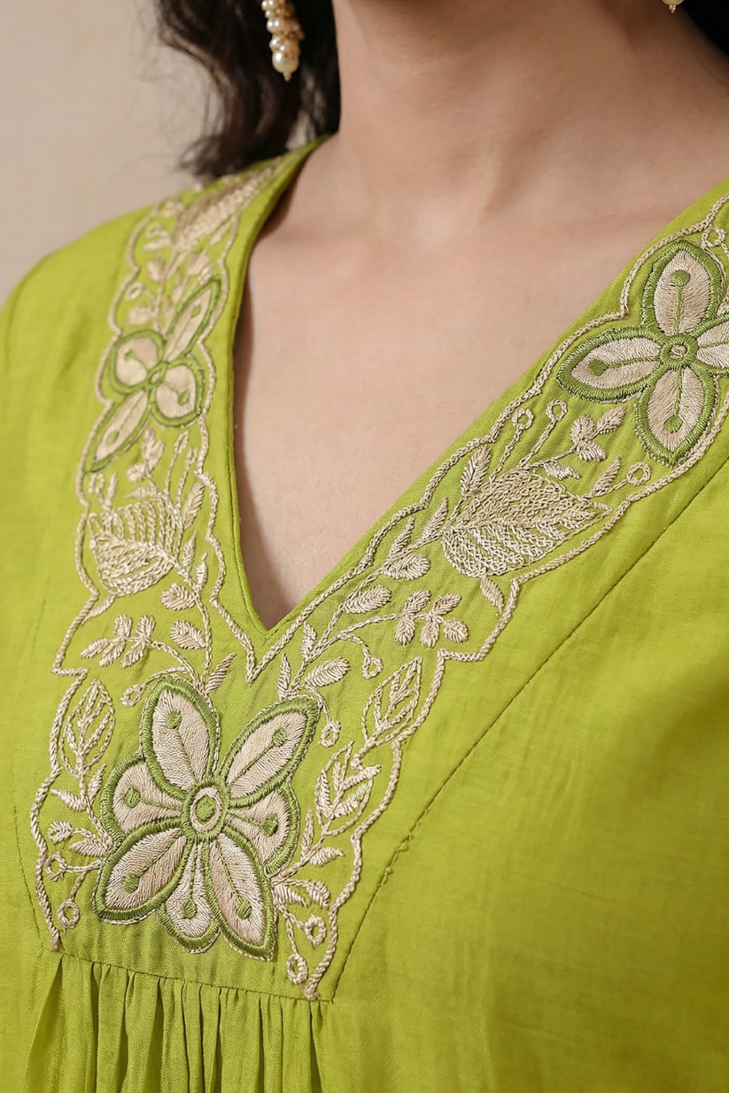 Woman wearing lime green embroidered kurta set with dupatta and straight pants for festive ethnic wear