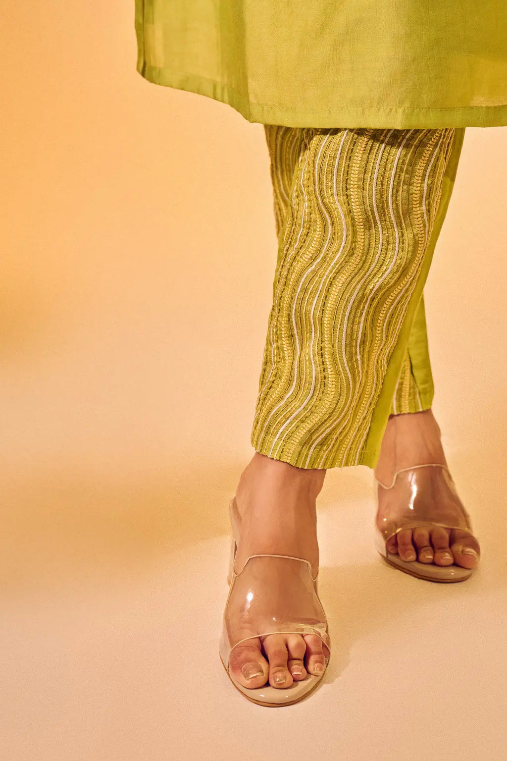 Close-up of lime green printed pants paired with sleeveless ethnic co-ord set for women