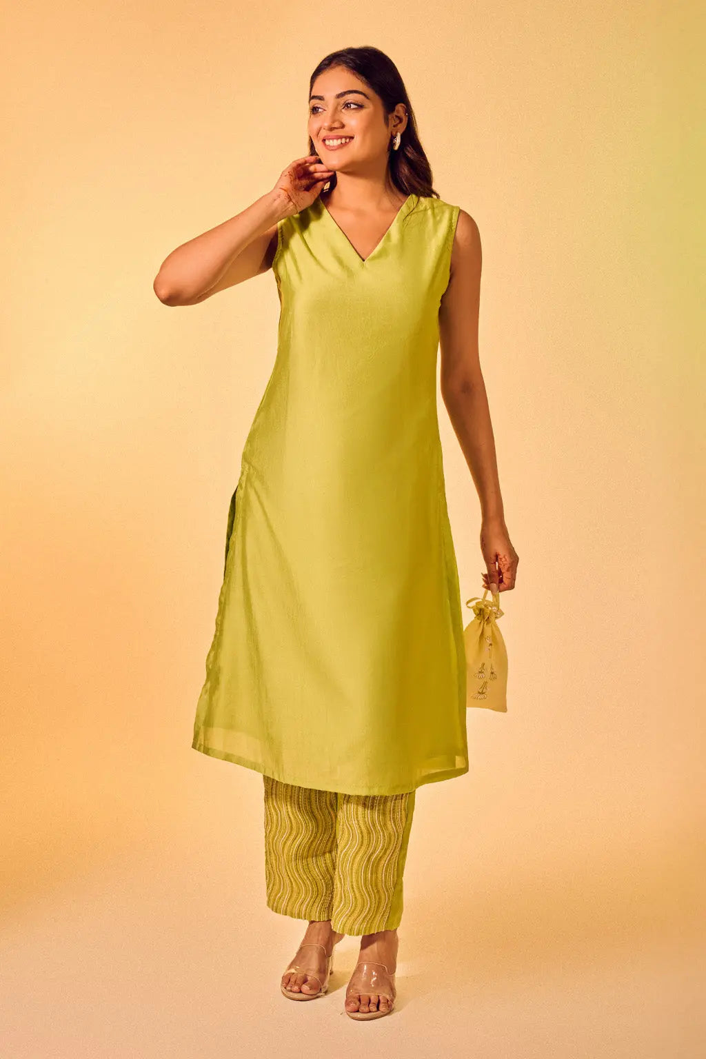 Woman wearing lime green sleeveless co-ord set with V-neck kurta and printed pants