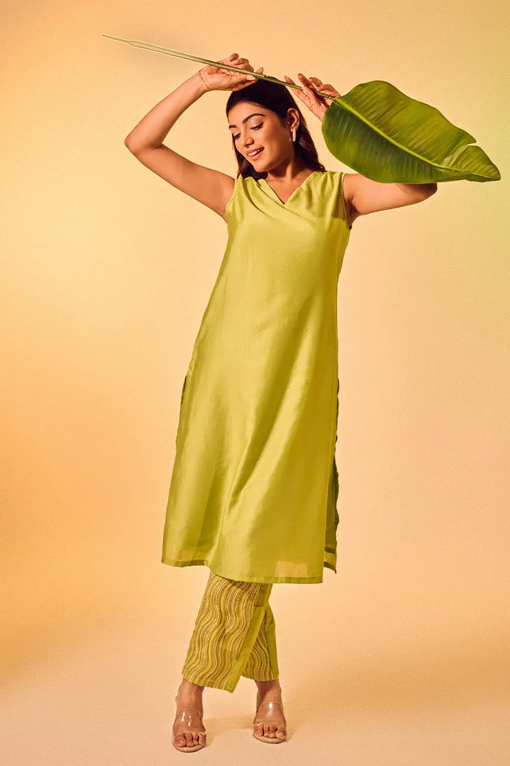 Woman wearing lime green sleeveless ethnic co-ord set with V-neck kurta and printed pants