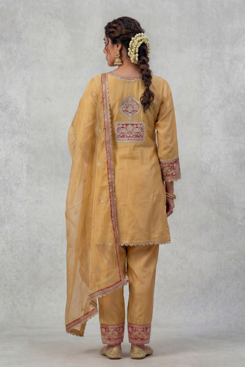 Back view of women mustard embroidered kurta set