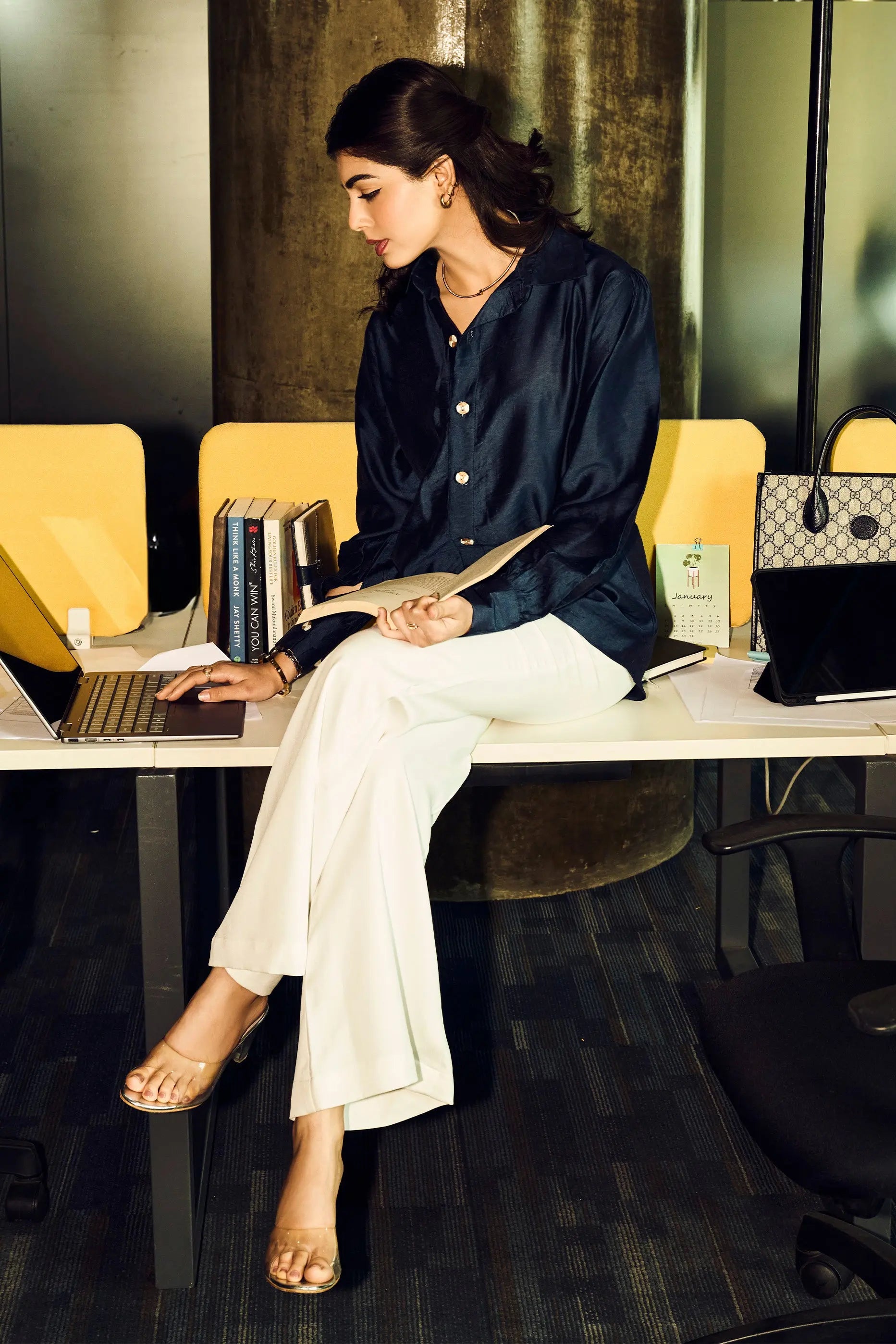 Woman wearing a navy blue Chanderi shirt with white pants in a smart office wear look