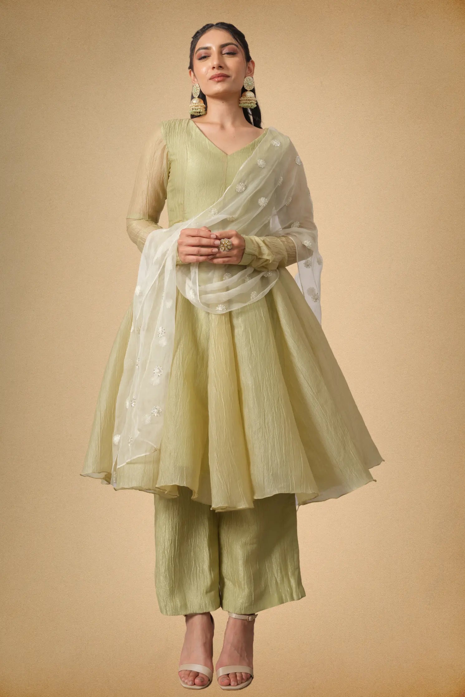 Front look of olive green flared Anarkali suit set