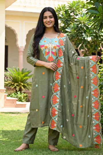 Woman wearing olive green embroidered kurta set with multicolor floral dupatta and straight pants