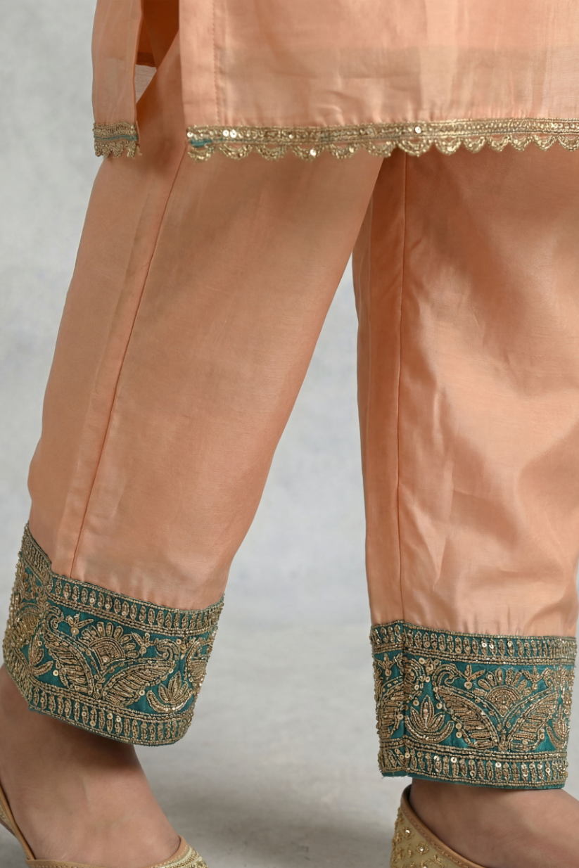 Detailed embroidered border design on peach teal ethnic pants