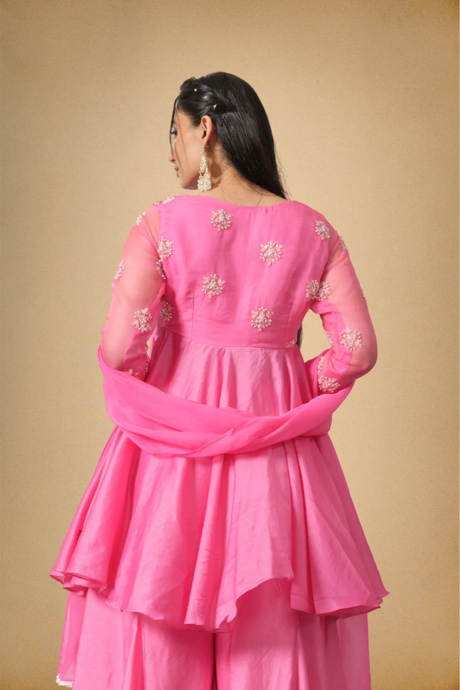 Back view of women pink Chanderi kurti sharara set