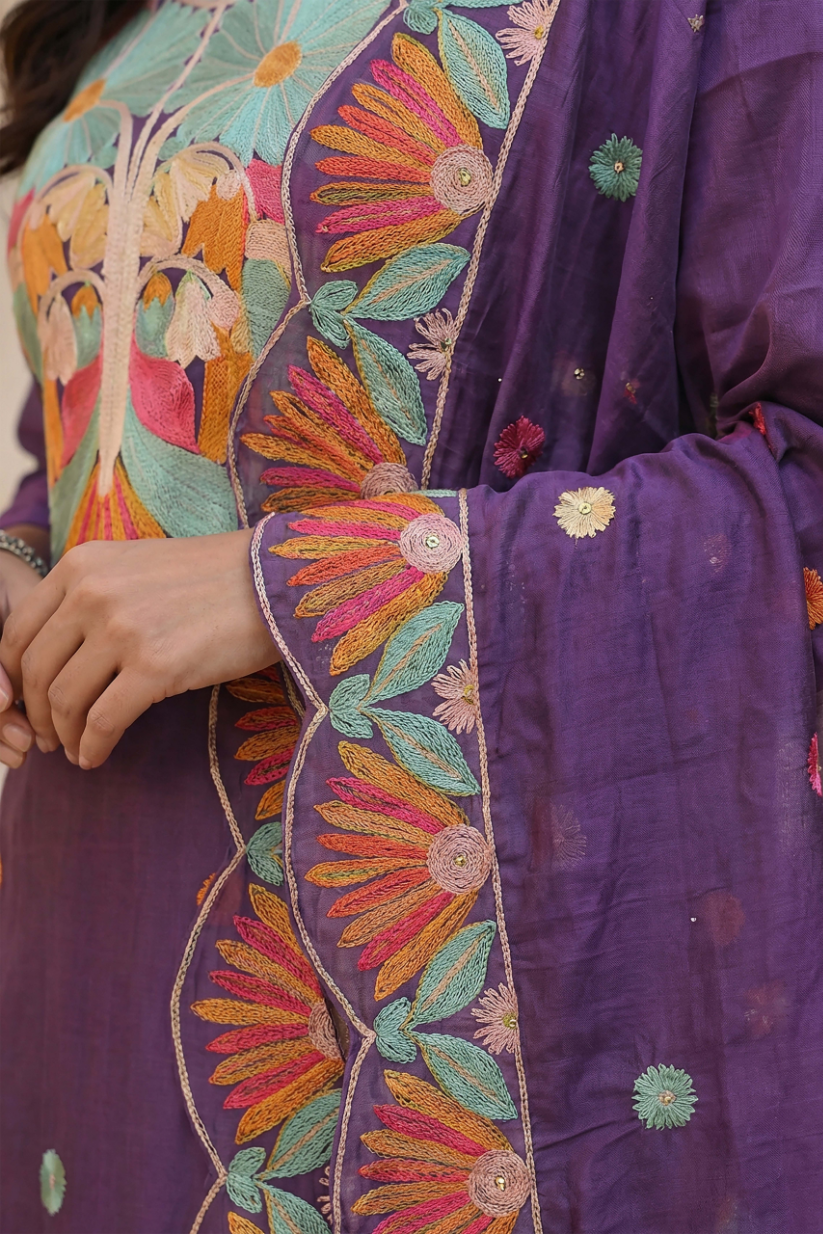 Close-up of embroidered border detailing on purple statement dupatta