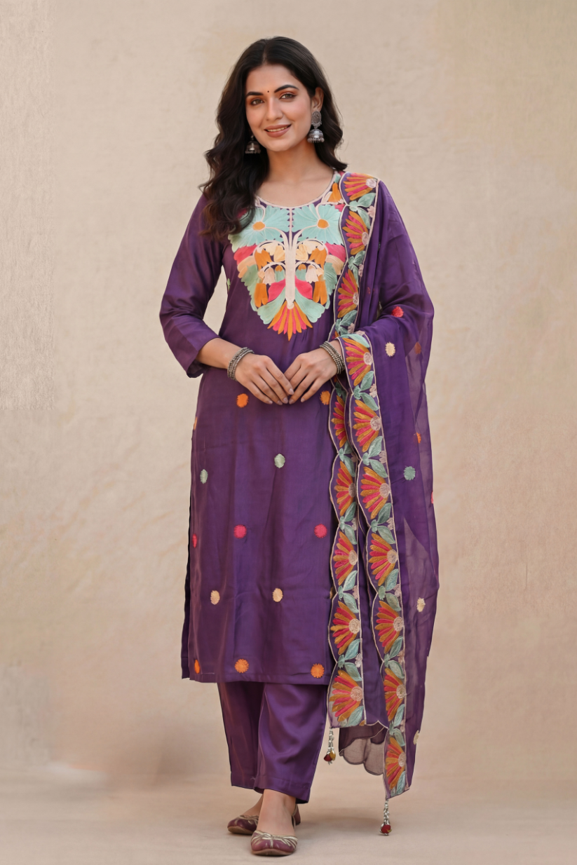 Woman wearing purple festive embroidered kurta set with dupatta and straight pants