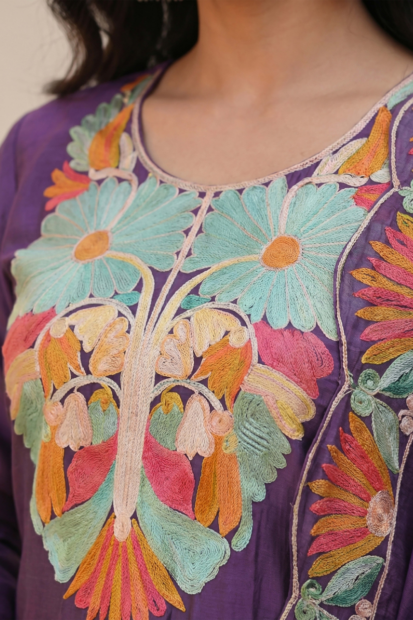 Close-up of multicolor floral embroidery on purple ethnic kurta neckline for women