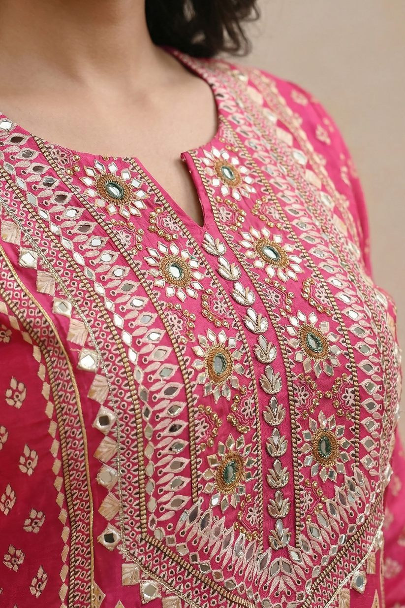 Close-up of embroidered neckline on rani pink festive kurta with intricate ethnic detailing