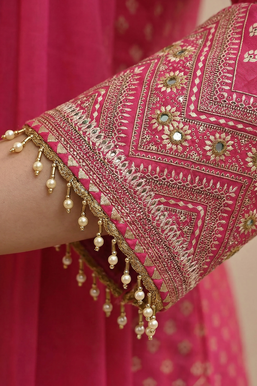 Detailed sleeve border embroidery on rani pink ethnic kurta with festive embellishments