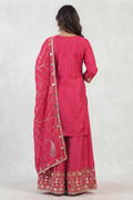Back view of women rani pink embroidered sharara set