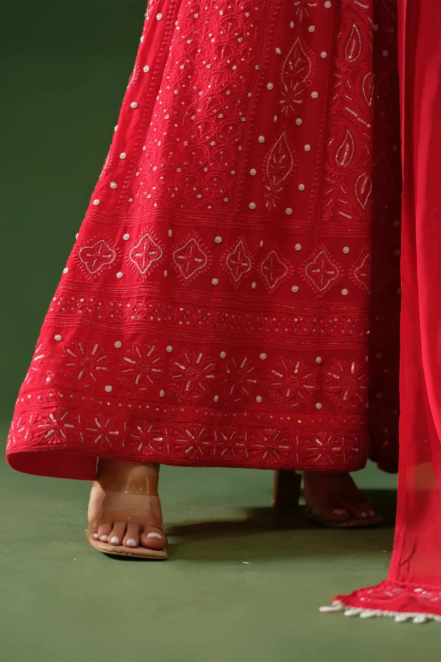 Detailed view of chikankari embroidery on red Anarkali suit