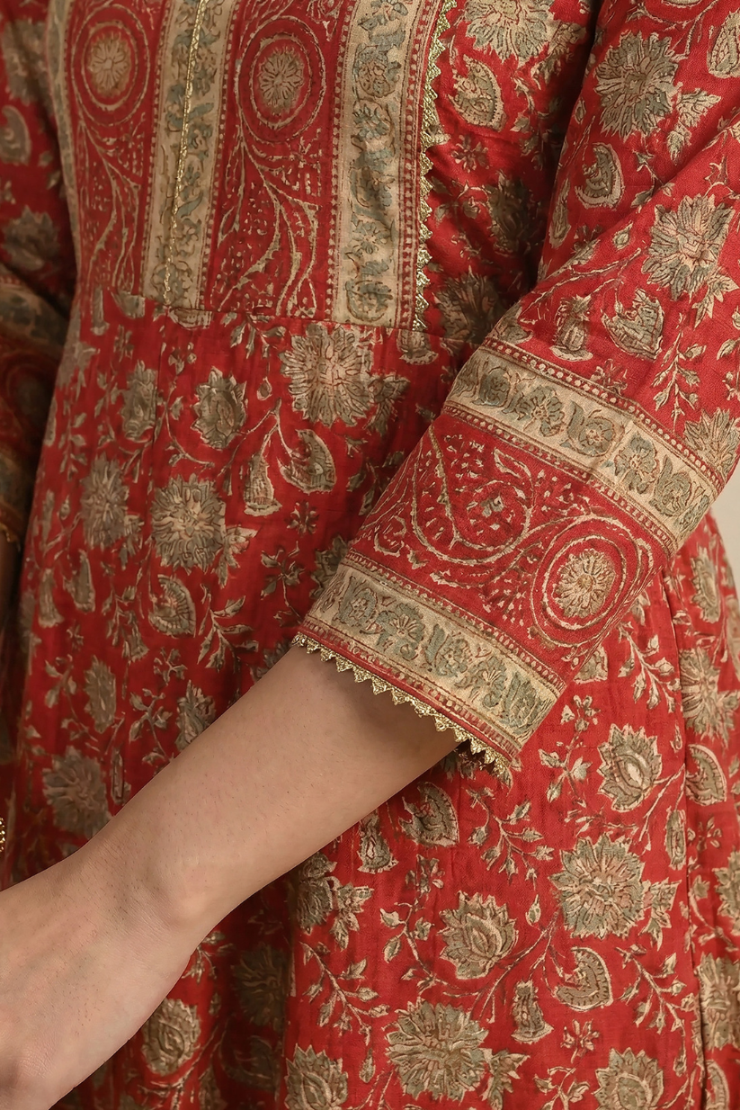 Close-up of red printed Anarkali kurta sleeve featuring intricate traditional motifs, ethnic border detailing, and festive design craftsmanship for women ethnic wear