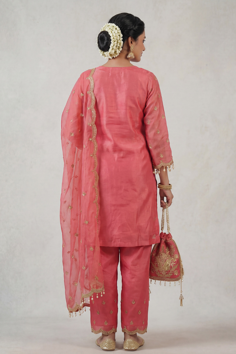 Back view of women rose pink embroidered kurta set