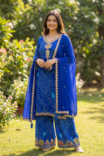 Woman wearing royal blue embroidered kurta palazzo set with matching dupatta front view for women festive ethnic wear outdoors