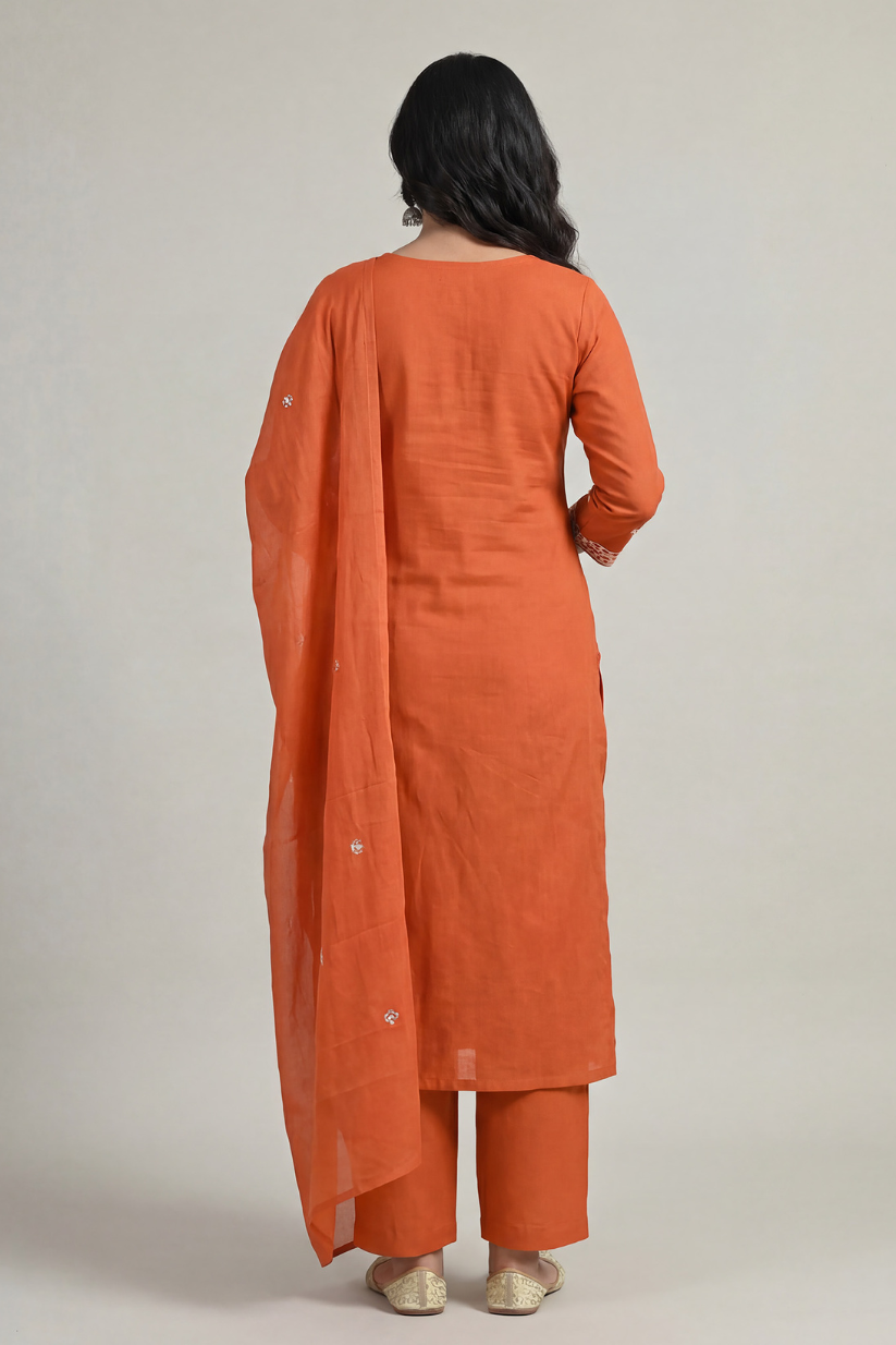 Back view of rust orange embroidered kurta set with dupatta and straight pants