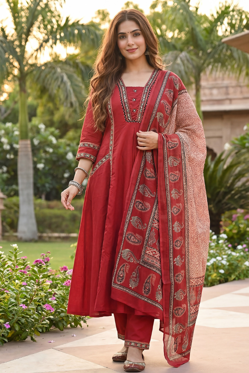 Woman wearing rust red A-line kurta pant set with printed dupatta