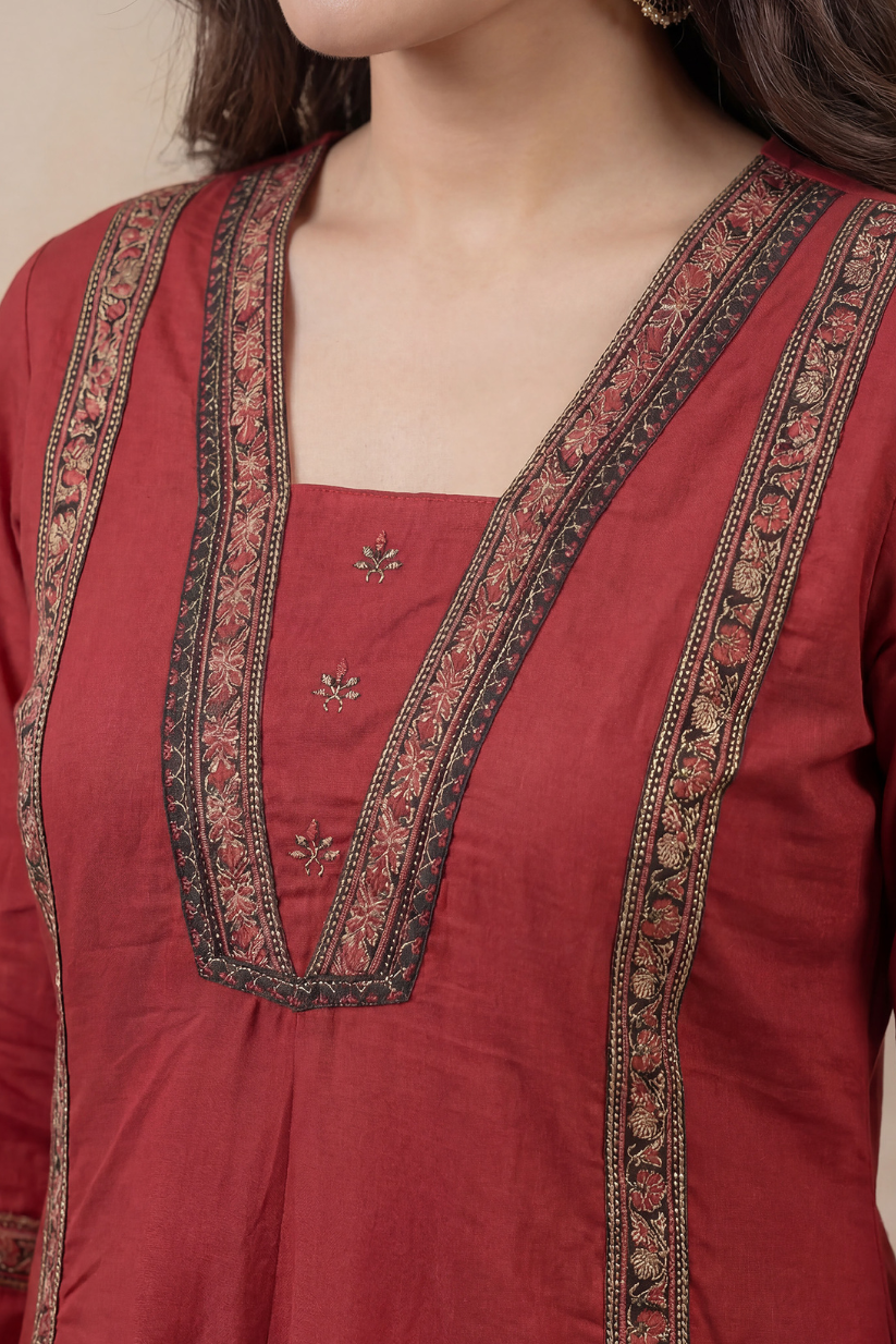 Woman wearing rust red A-line kurta pant set with printed dupatta