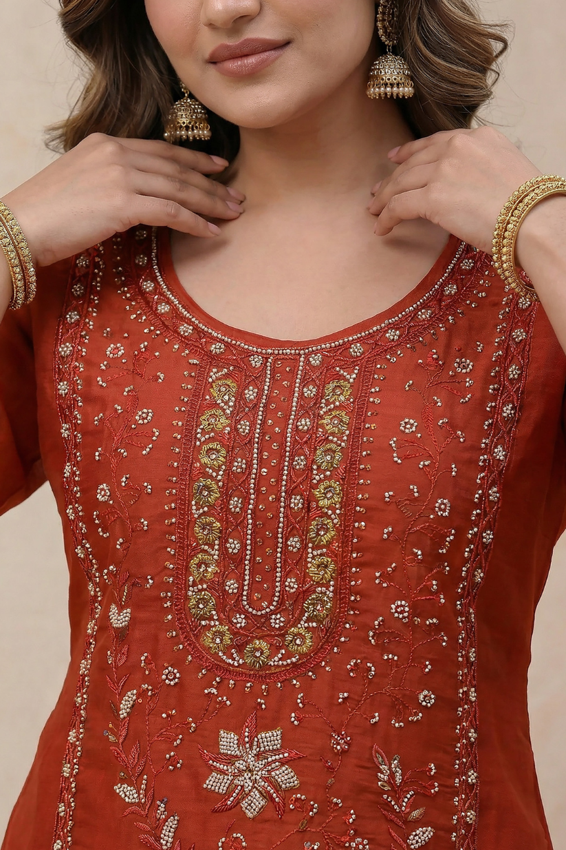 Woman wearing rust red embroidered kurta set with straight pants