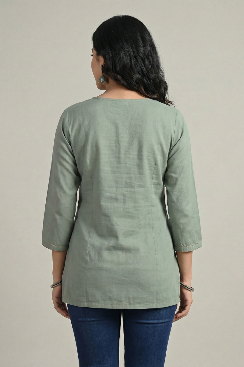 Back view of sage green cotton short kurti for women with three-quarter sleeves and casual fit