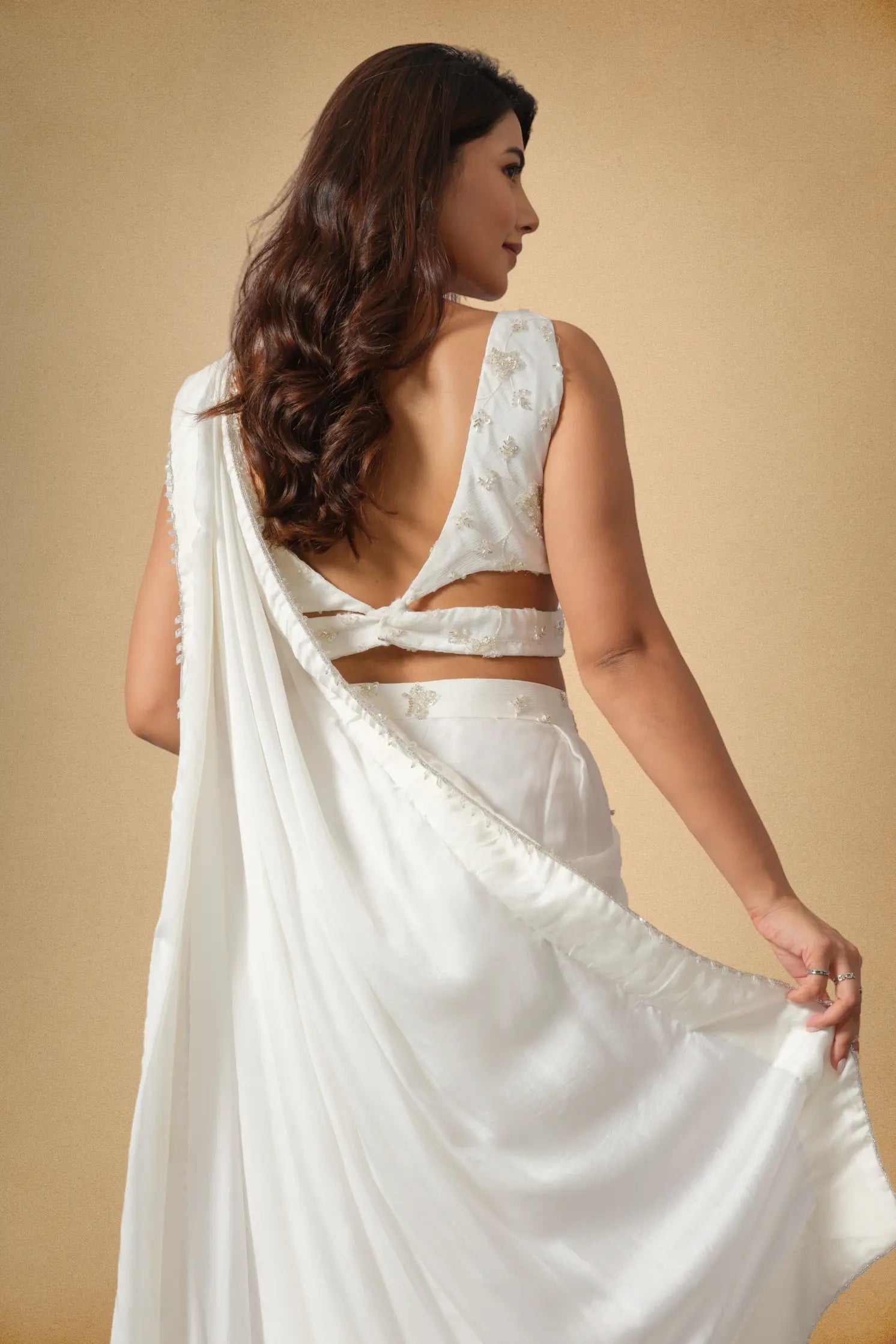 Back view of women white party wear saree