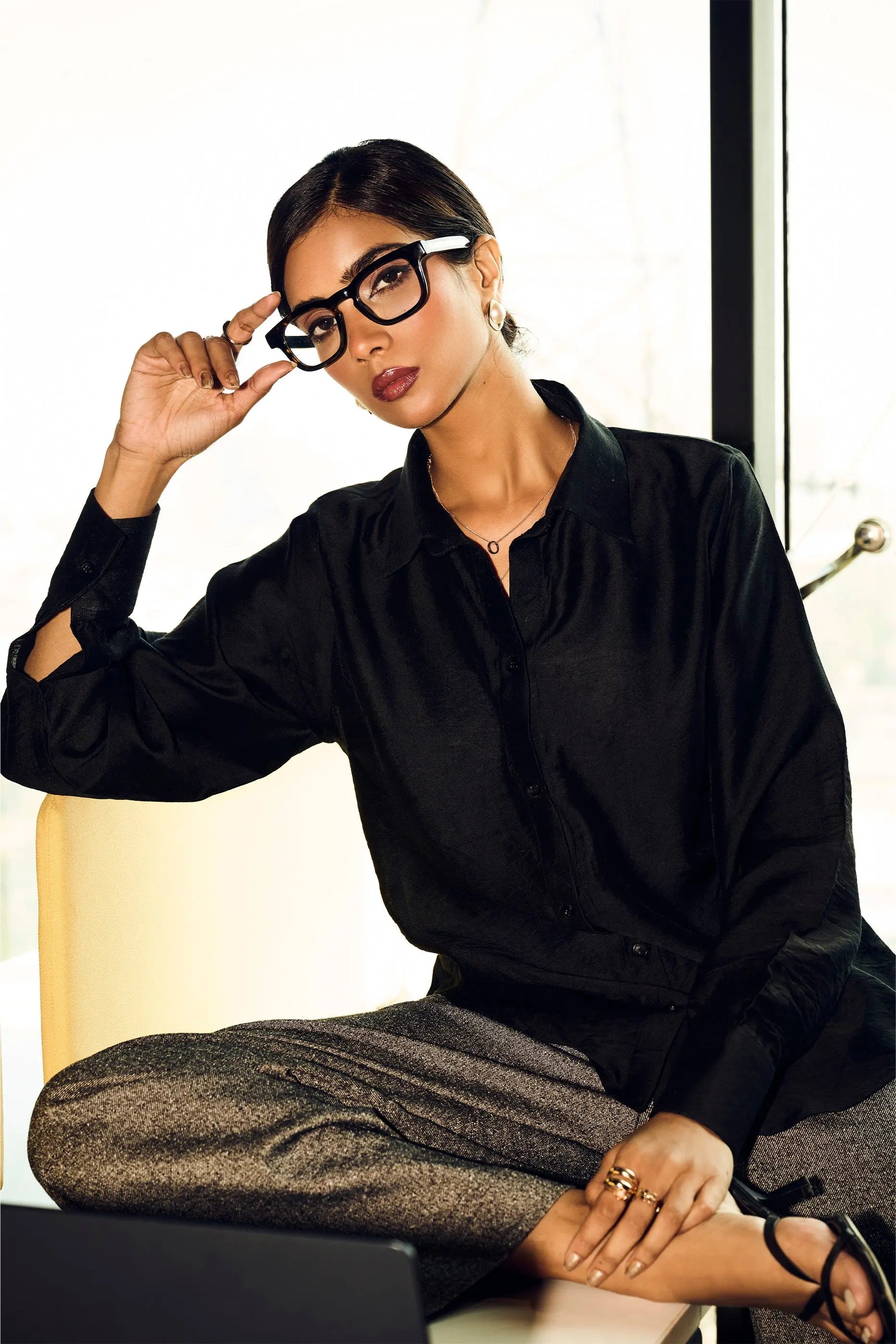 Woman wearing a black Chanderi regular fit shirt styled for smart casual office wear and modern formal fashion